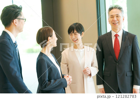 オフィスで談笑するビジネスパーソン オフィスで談笑するビジネスパーソン 121282783