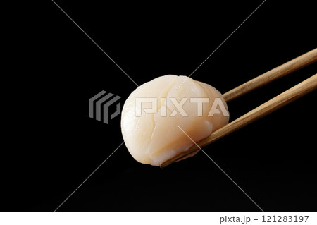 箸で持ち上げた帆立の貝柱の刺身 箸で持ち上げた帆立の貝柱の刺身 121283197