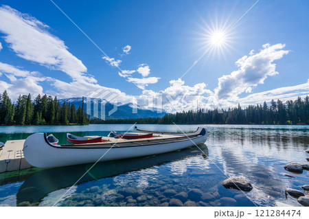 White Canoe on dock at Beauvert Lake (Lac Beauvert). Jasper National Park summer landscape. Alberta, Canada. 121284474