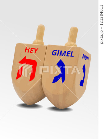 Two wooden dreidels spinning on white background are ready for a game during hanukkah celebration 121284611
