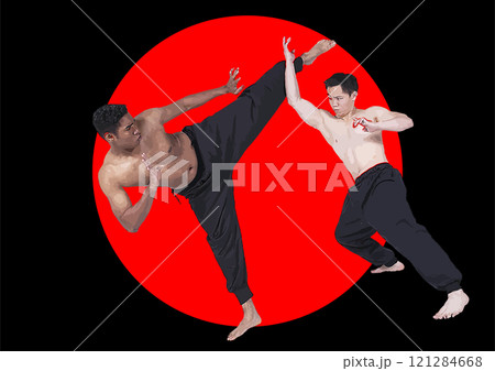 Two men are practicing martial arts in front of a japanese flag, one kicking the other 121284668