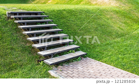 Outdoor staircase on green grassy lawn slope Outdoor staircase on green grassy lawn slope 121285816