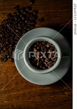 White cup with coffee beans  121287620