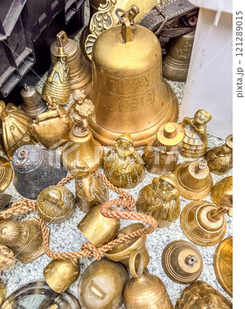 A collection of antique brass bells of various shapes and sizes. High quality photo A collection of antique brass bells of various shapes and sizes. High quality photo 121289015