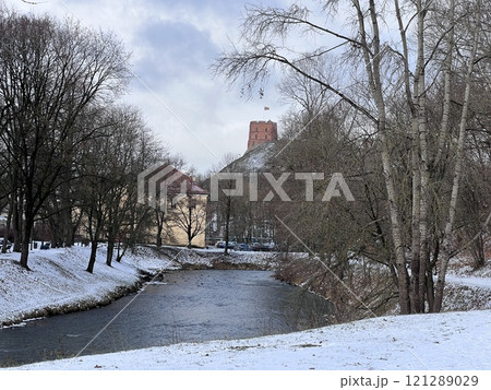 View of the Upper Castle Gediminas Tower in winter on the snow covered hill from from Sventaragis valley park, Vilnius, Lithuania  121289029