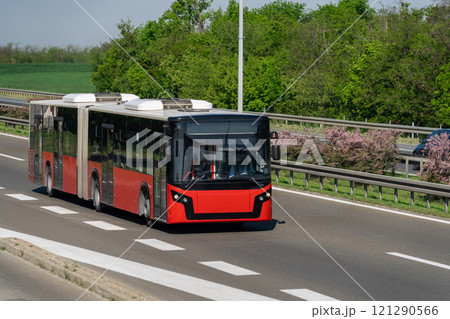 Red city bus on the highway 121290566