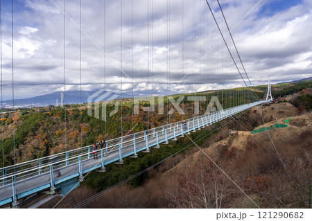 View of the Mishima Skywalk Bridge, the longest foot suspension bridge in Japan, on a sunny day with moving clouds in background 121290682