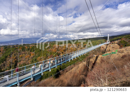 View of the Mishima Skywalk Bridge, the longest foot suspension bridge in Japan, on a sunny day with moving clouds in background 121290683