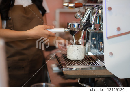 Young barista making coffee, coffee preparation service concept. Young barista making coffee, coffee preparation service concept. 121291264