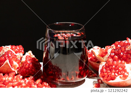 Natural organic pomegranate juice is garnished with pomegranate seeds 121292242