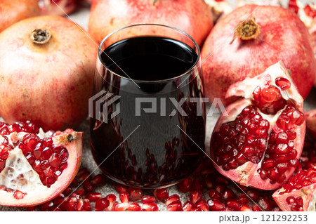 Natural pomegranate juice in a glass, close-up. Natural pomegranate juice in a glass, close-up. 121292253