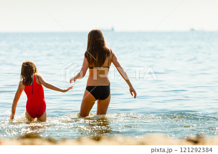 Little girl kid and woman mother in sea water. Fun 121292384