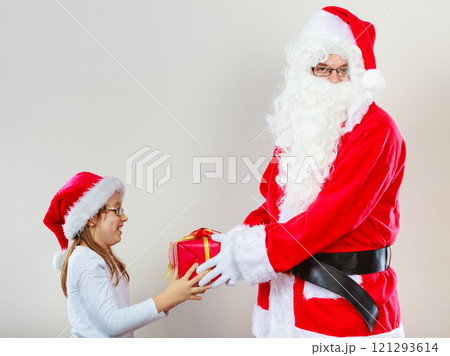 Christmas Santa Claus giving girl present 121293614