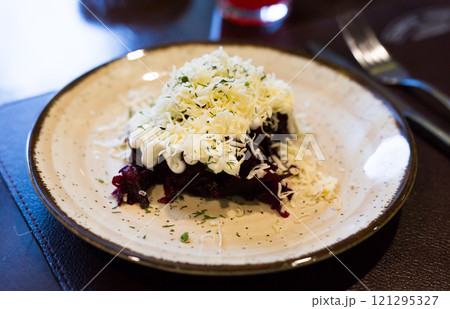 Mix of beets, cheese, mayonnaise on a plate in restaurant 121295327