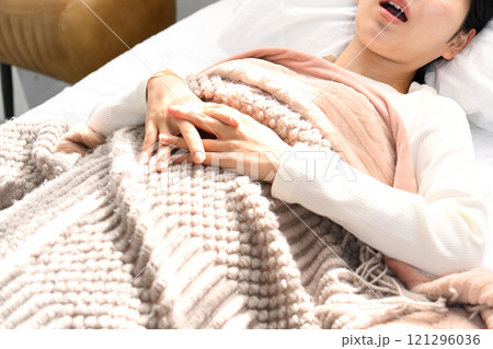 ベッドの上でいびきをかき寝るアジア人女性 ベッドの上でいびきをかき寝るアジア人女性 121296036