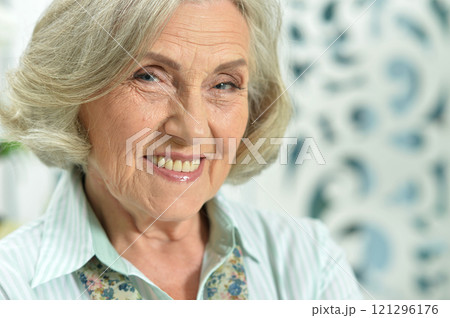 Portrait of smiling senior woman posing at home 121296176