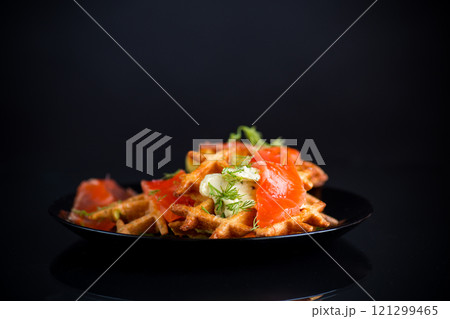 vegetable potato waffles with spread and lightly salted red fish in a plate 121299465