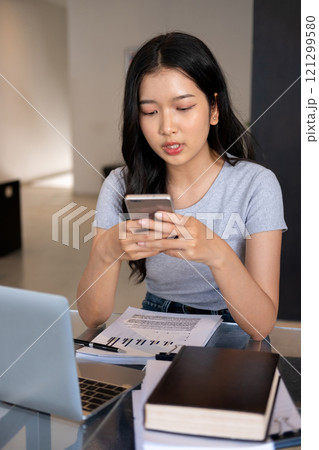 Young woman relaxing with smartphone. 121299580