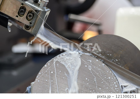 The band saw cutting machine cutting the metal shaft parts with coolant method. 121300251