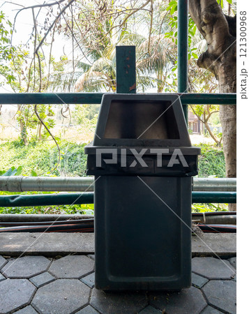 A old plastic trash with the black garbage bag. A old plastic trash with the black garbage bag. 121300968