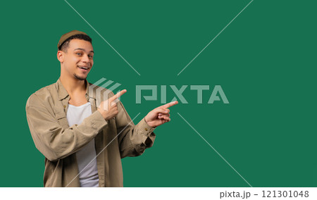 Stylish smiling multiracial man pointing right side, copy space or advertising. 121301048