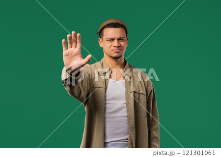 Serious man showing rejecting gesture by stop palm sign. Not allow, prohibition Serious man showing rejecting gesture by stop palm sign. Not allow, prohibition 121301061