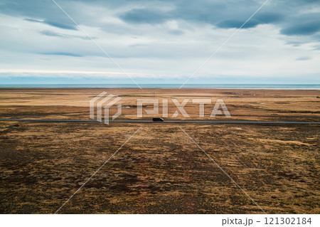 Icelandic landscape with van driving through grassland in autumn 121302184