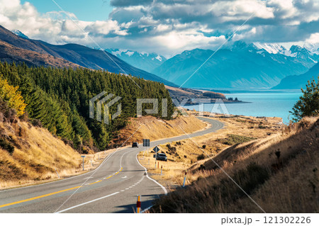 Scenic Peters lookout with winding road and Mount Cook and Lake Pukaki on sunny day in autumn at New Zealand 121302226