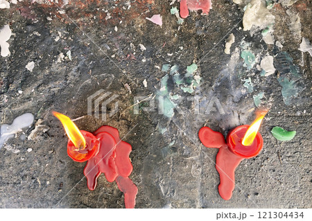 burning candles on stone steps. Candles on a tombstone. melted wax burning candles on stone steps. Candles on a tombstone. melted wax 121304434