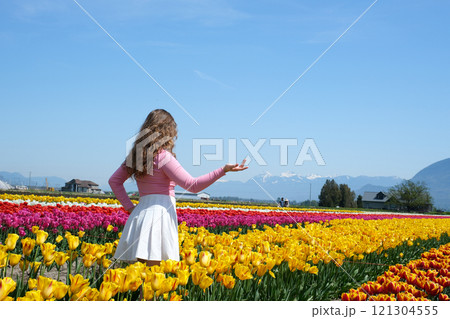 beautiful happy woman in a field of pink tulips smiling beautiful happy woman in a field of pink tulips smiling 121304555