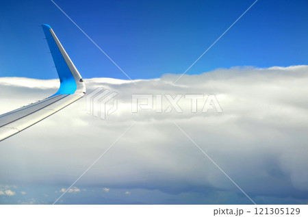Blue sky and silky white clouds with stunning shapes and colorful views over the clouds Blue sky and silky white clouds with stunning shapes and colorful views over the clouds 121305129