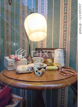 Sewing accessories on a wooden table in a tailor shop. Vintage 121305357