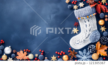 A white, crocheted holiday sock lies on a blue background surrounded by Christmas décor 121305367