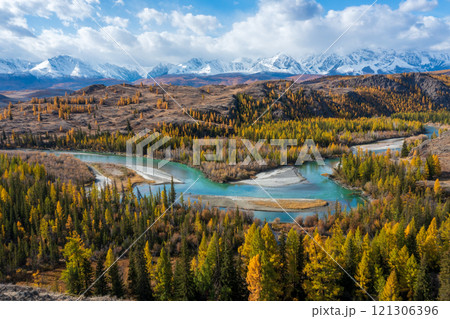 Scenic river and forest landscape in autumn with distant mountain peaks 121306396