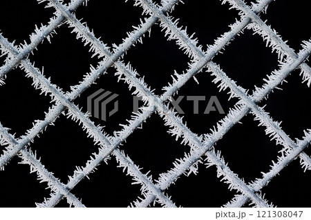 Frosty woven wire fence in cold winter Frosty woven wire fence in cold winter 121308047