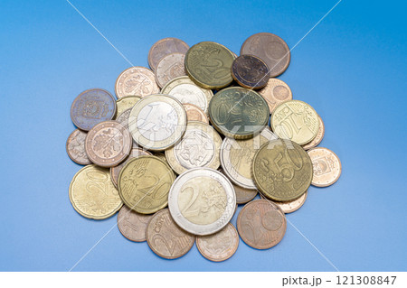 a handful of euro cent coins on a blue background 121308847