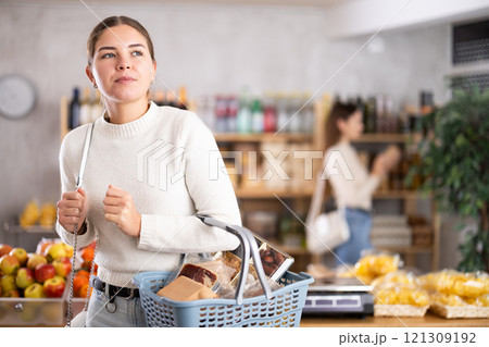 Young woman choosing groceries in the supermarket Young woman choosing groceries in the supermarket 121309192