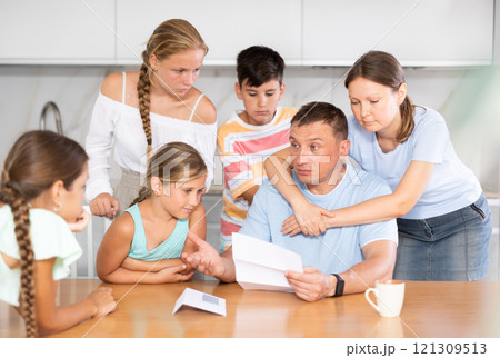 Big family reading upset letter 121309513