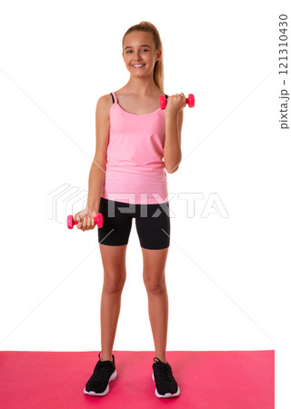 Healthy fitness teen girl in full length doing exercises with dumbbells isolated over white background 121310430