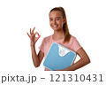 Young attractive girl showing ok sign and holding weighing scale. Girl make OK gesture to say yes, standing over white background isolated 121310431