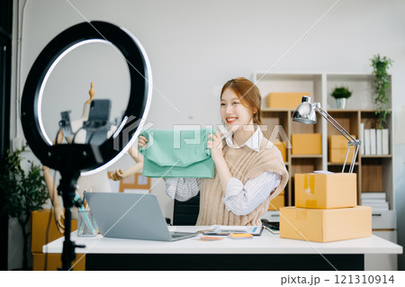Fashion blogger concept, Young Asian women selling clothes on video streaming.Startup small business SME 121310914