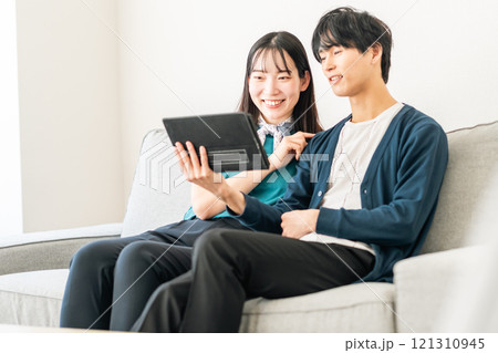 タブレットで動画を見るカップル 121310945