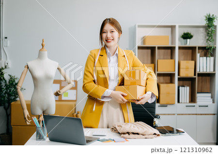 Startup small business SME, Entrepreneur owner woman using smartphone or tablet taking receive and checking online purchase shopping order Startup small business SME, Entrepreneur owner woman using smartphone or tablet taking receive and checking online purchase shopping order 121310962