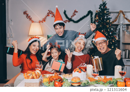 Happy family with gifts celebrating Christmas together 121311604
