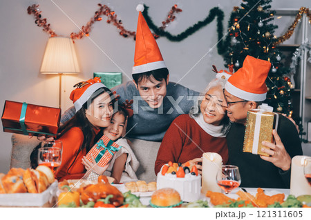 Happy family with gifts celebrating Christmas together 121311605