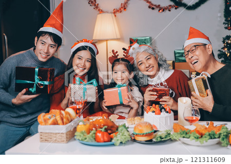 Happy family with gifts celebrating Christmas together Happy family with gifts celebrating Christmas together 121311609