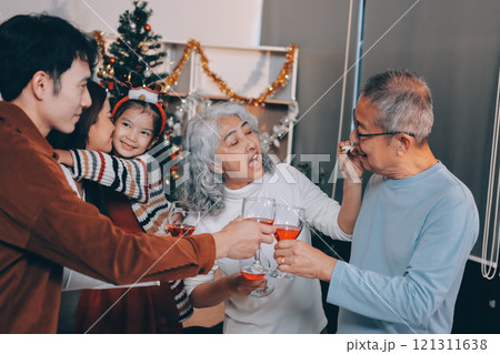Merry Christmas! Happy family are having dinner at home. Celebration holiday and togetherness near tree. 121311638