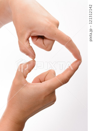 Two hands forming a small heart shape with fingers. Two hands forming a small heart shape with fingers. 121312142