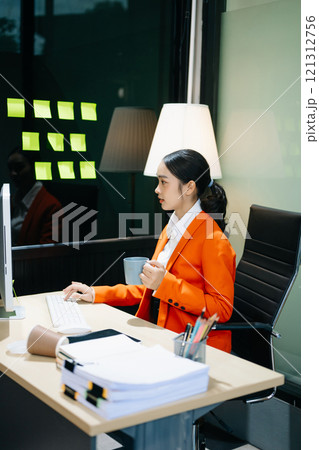 Business woman using tablet and laptop for doing math finance on an office desk, tax Business woman using tablet and laptop for doing math finance on an office desk, tax 121312756