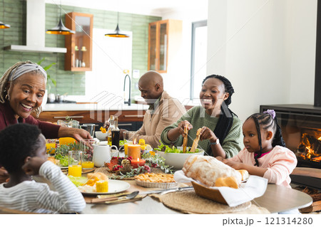 African american parents, children and grandparents celebrating at thanksgiving dinner, slow motion 121314280